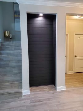 custom wine rack recessed into the wall next to some stairs