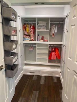 Walk in closet with a closet system and door hanger boxes